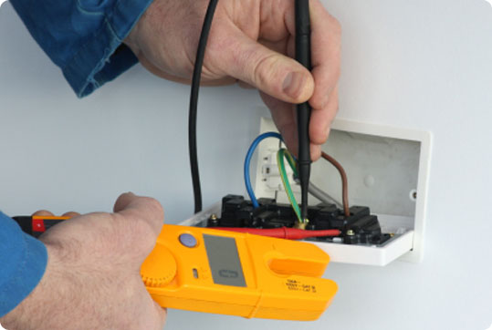 Electrician testing a socket in a home