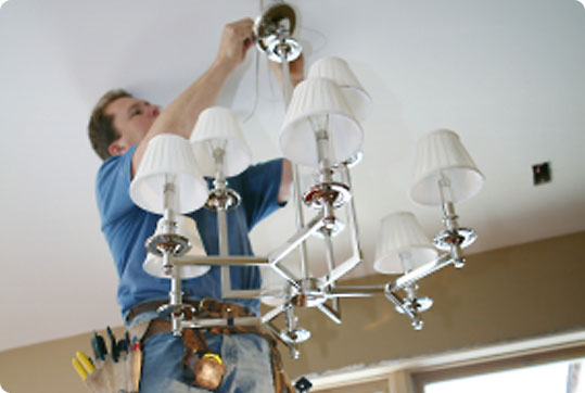 Electrician installing a light fitting